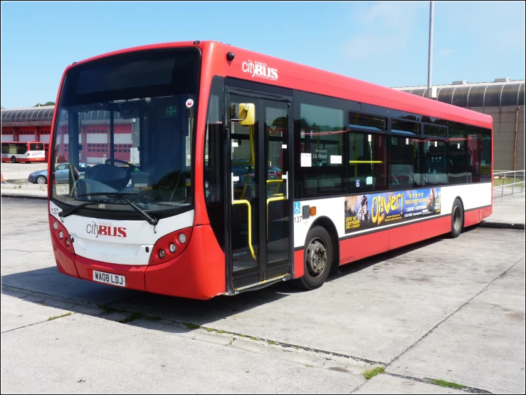 a red and white bus that is sitting in the street