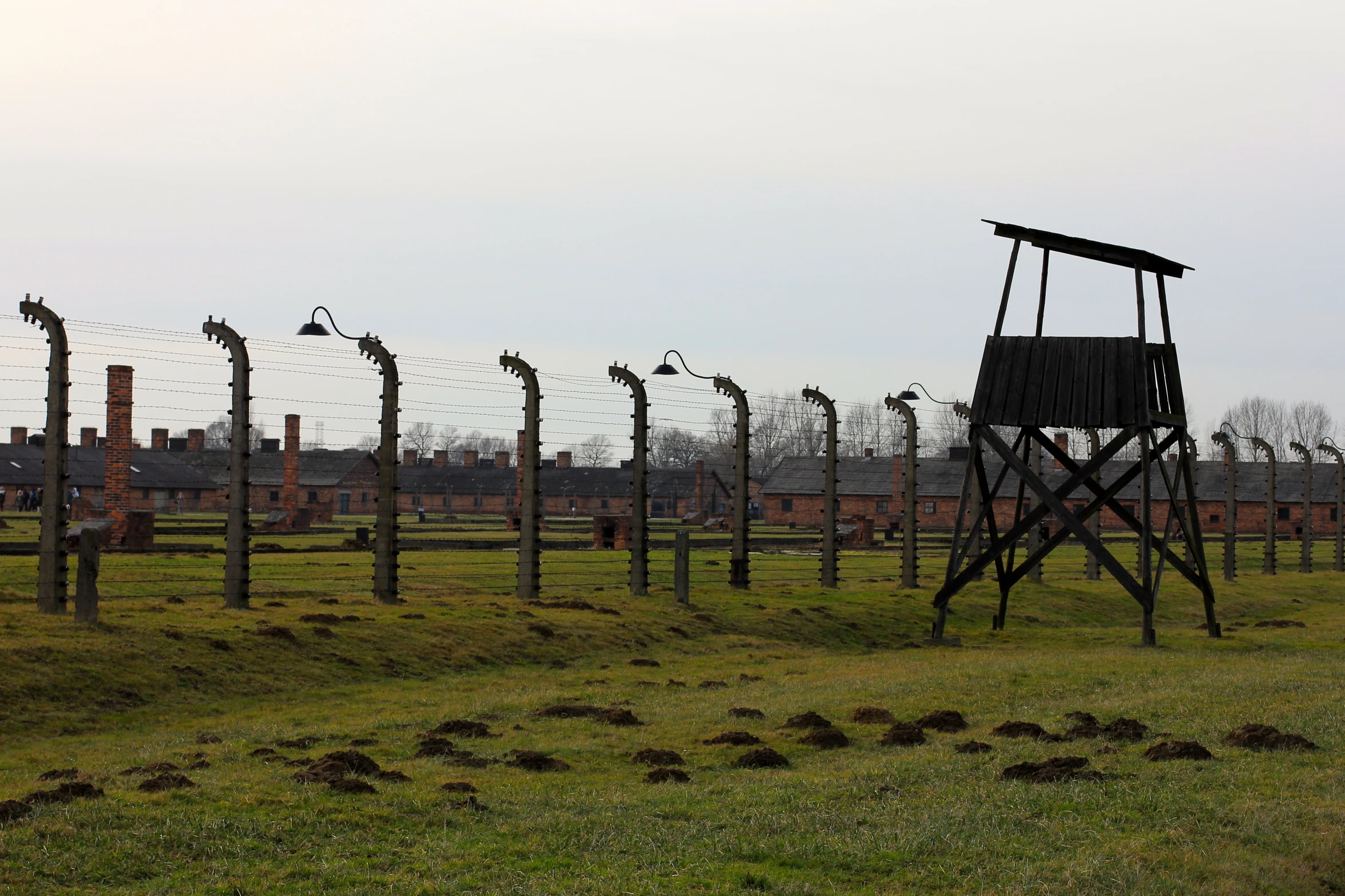 an old wooden tower in a barbed wire fence