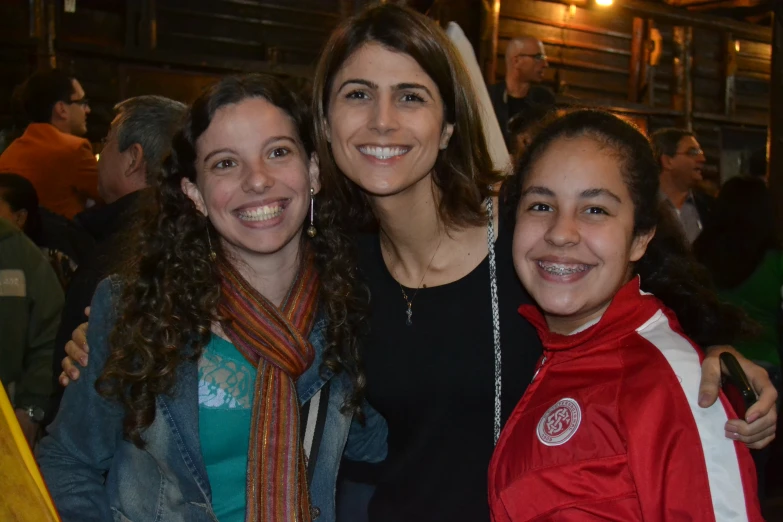 two women and one man posing for a picture together