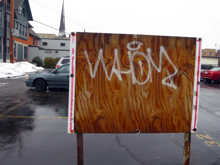 the sign in the foreground is now tagged with white graffiti