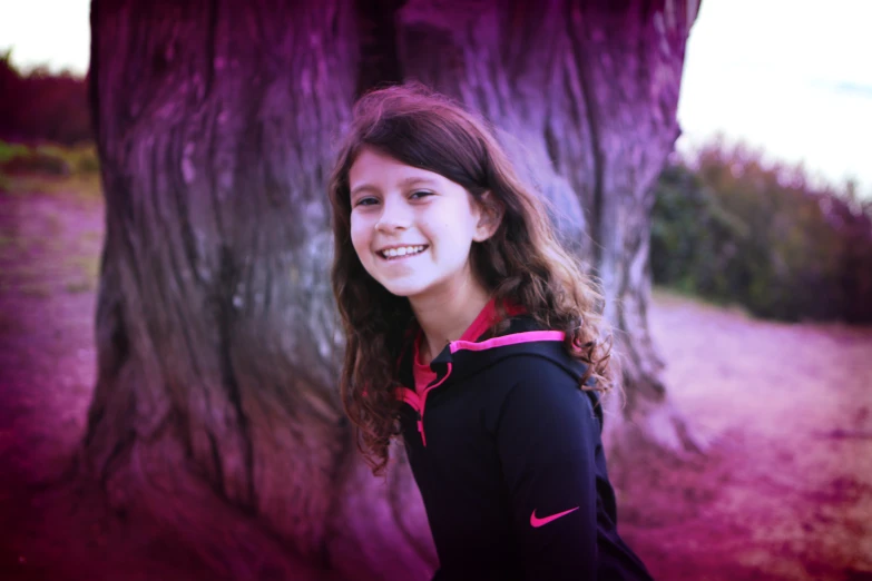 a  stands in front of a large tree