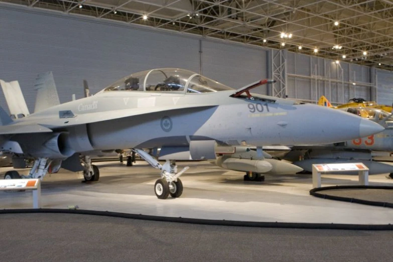 a blue fighter jet parked inside of a hangar