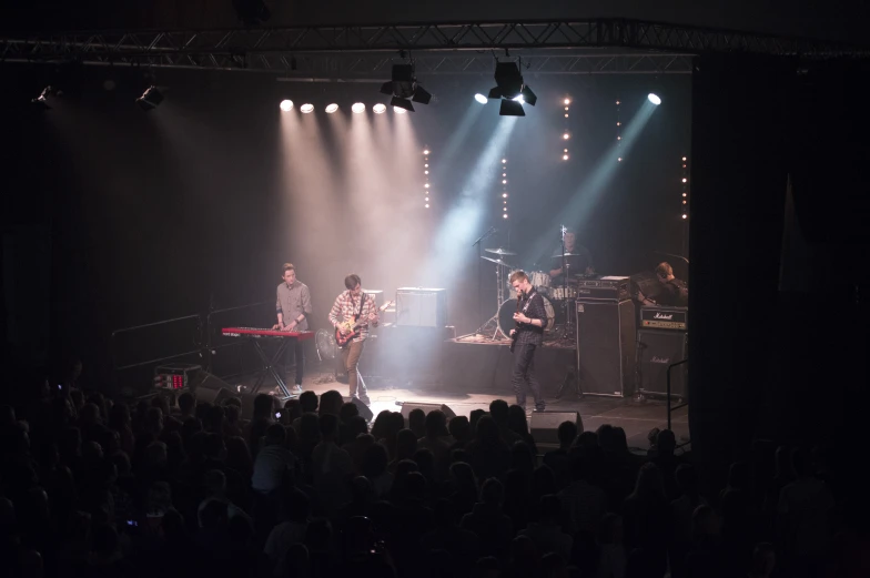 the band performs in front of a crowd at a concert