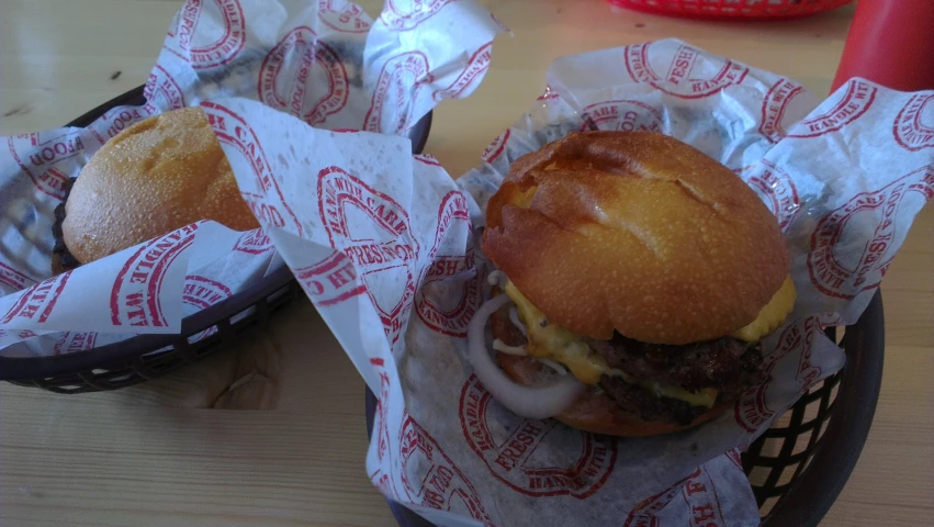 some burgers are sitting on a tray together