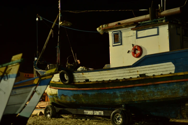 a fishing boat pulled up on dry land at night
