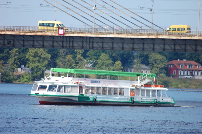 a ferry is traveling across a bridge over a body of water