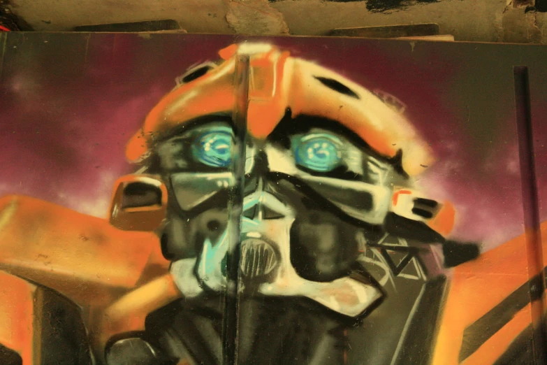 a graffiti on a wall depicts an orange firefighter