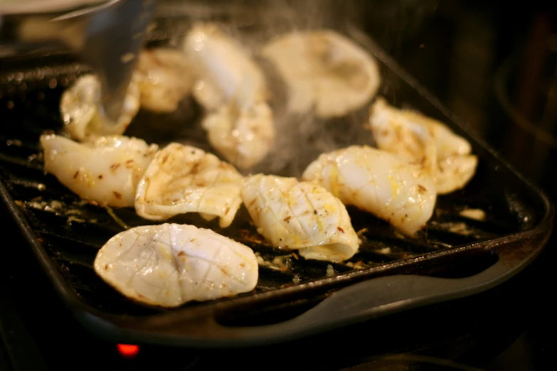 the food is being cooked in the wok