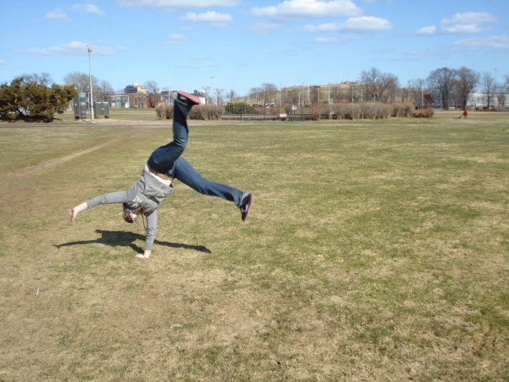 a boy jumps in the air on the grass