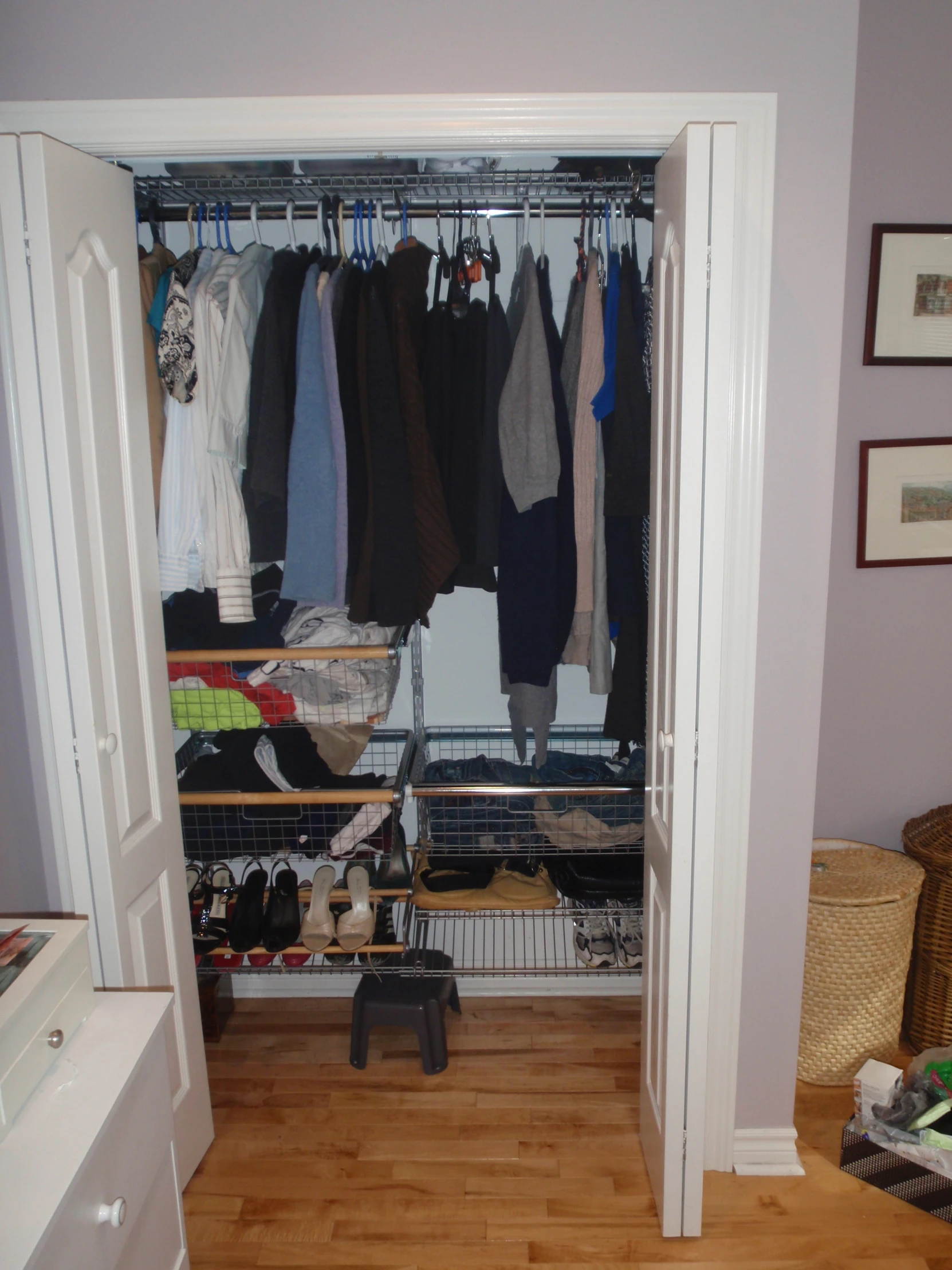 a walk in closet with clothes and other items