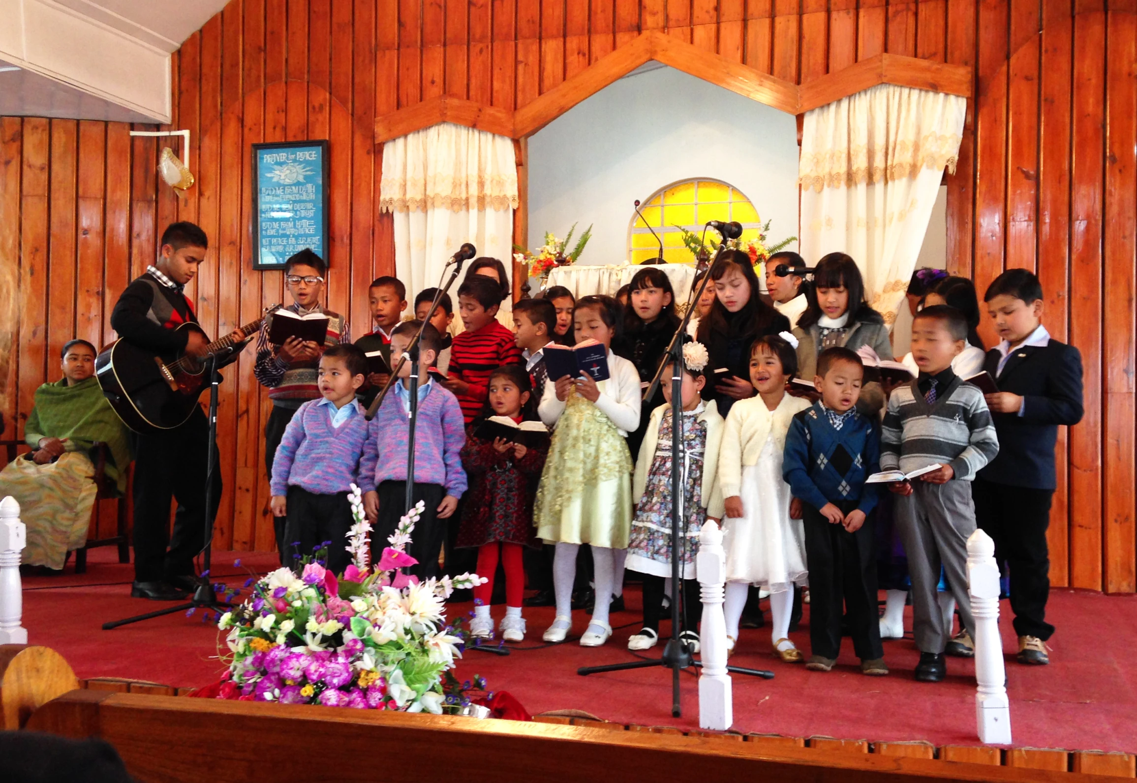 a group of children are gathered for a performance