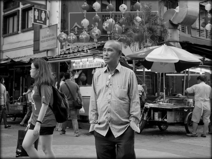 a black and white image of a man on a street