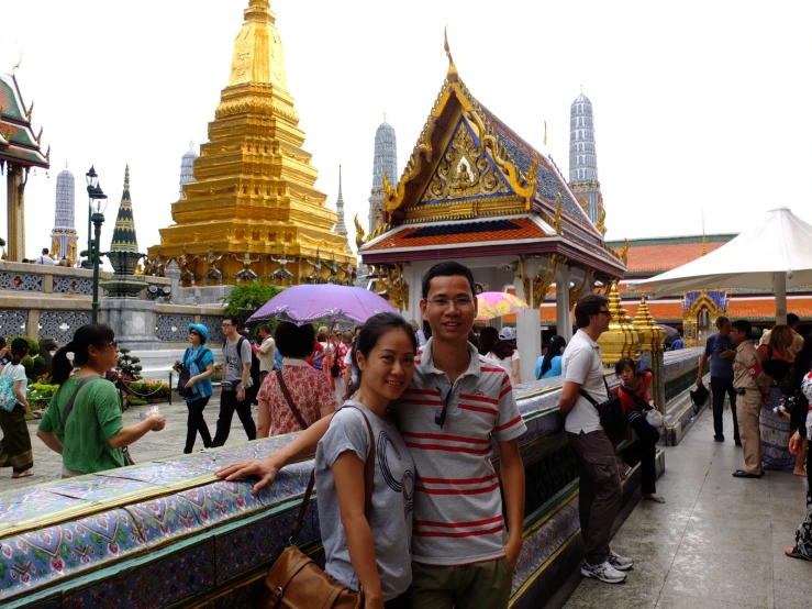 a man and a woman are posing for the camera