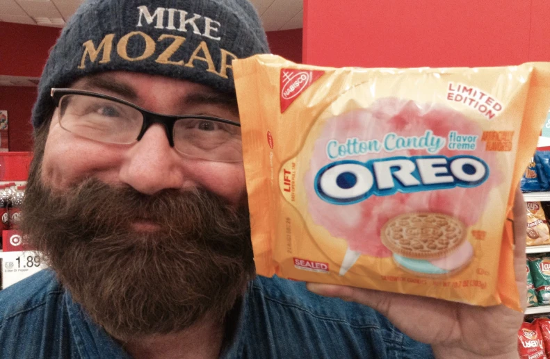 a man holding up a package of cereal