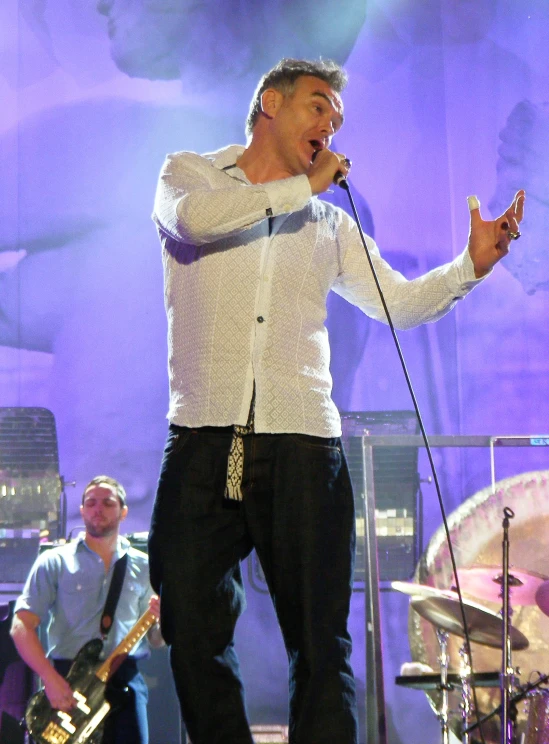 a man standing on a stage holding a microphone