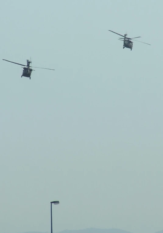 two black war plane flying in the air with propellers