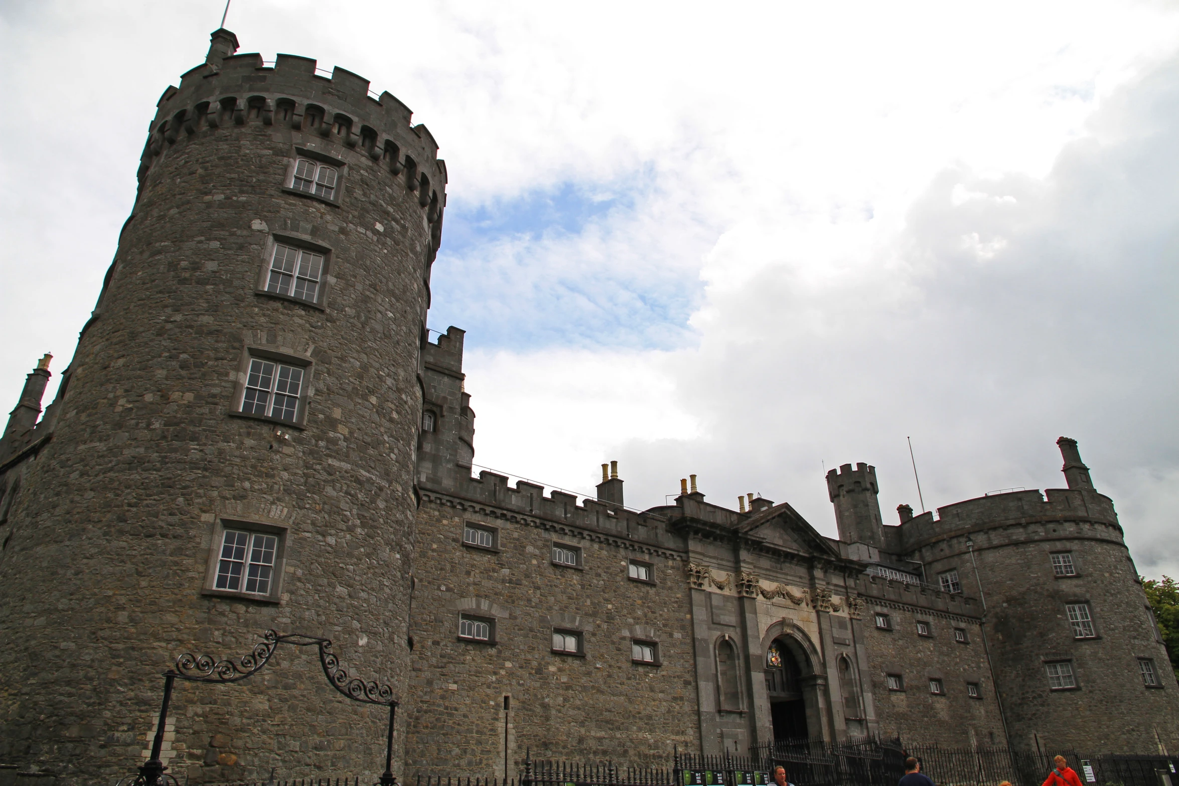 an ornate stone building with a gate and towers