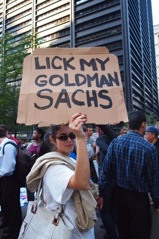 a person in white shirt holding up sign with words on it