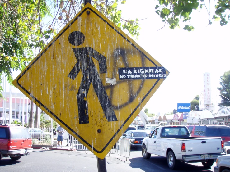 a sign is on a sidewalk in the city