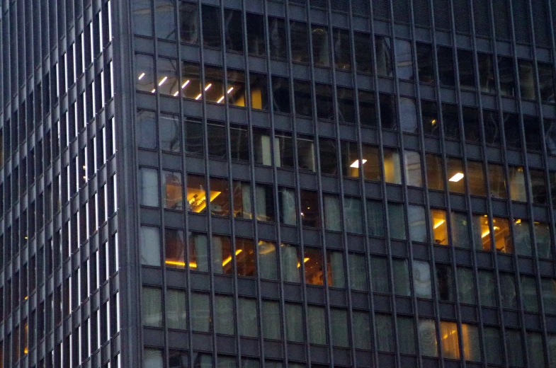 view from another skyscr at night to a street sign