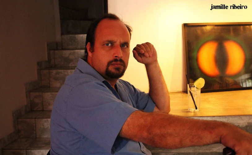 a man is sitting with his fist up in a living room