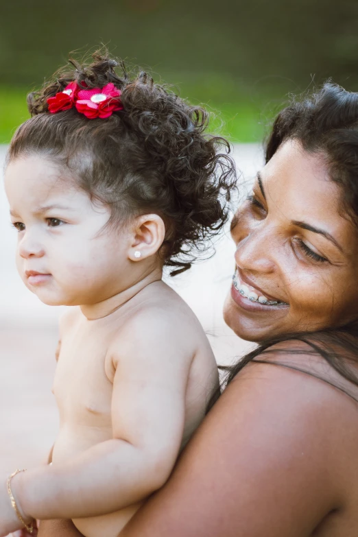 a woman holding a child with one arm