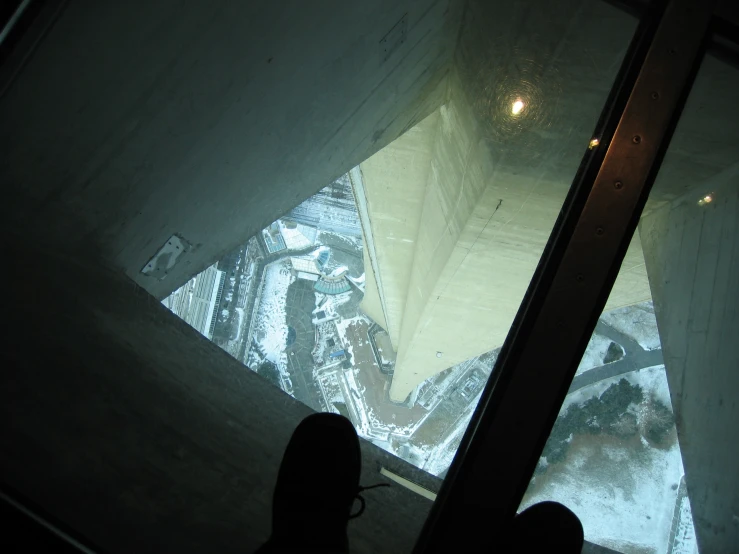 looking down into the snow covered ground from a tall glass tower