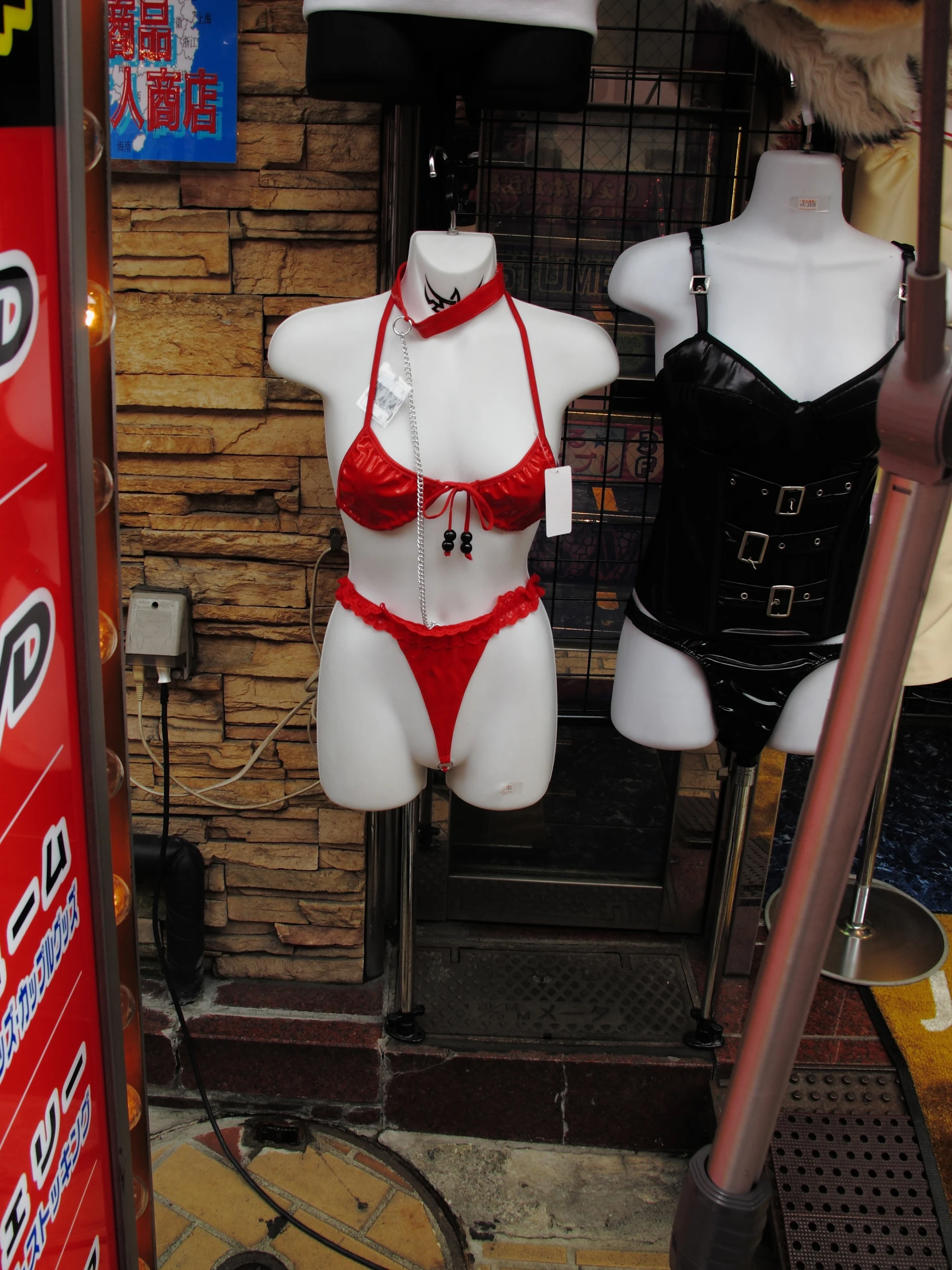 two female mannequins in a shop display in a window