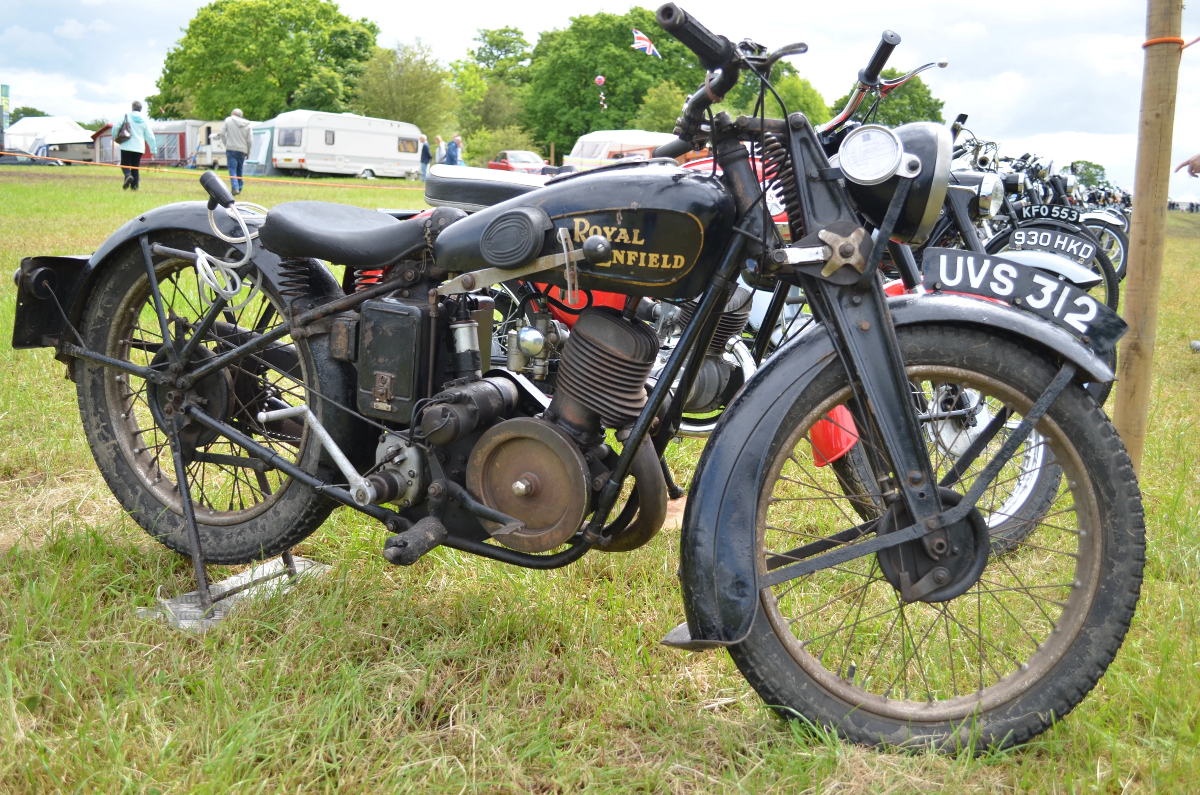 there is an old motorcycle that is parked in the grass