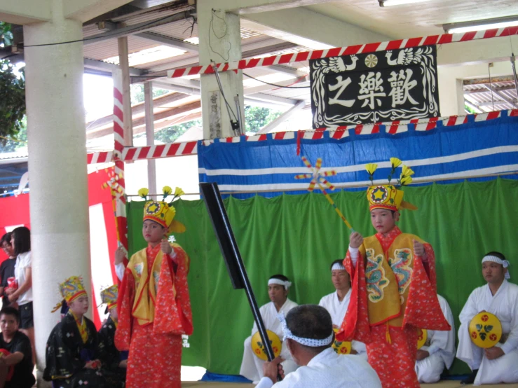 the performers are wearing orange and yellow clothing