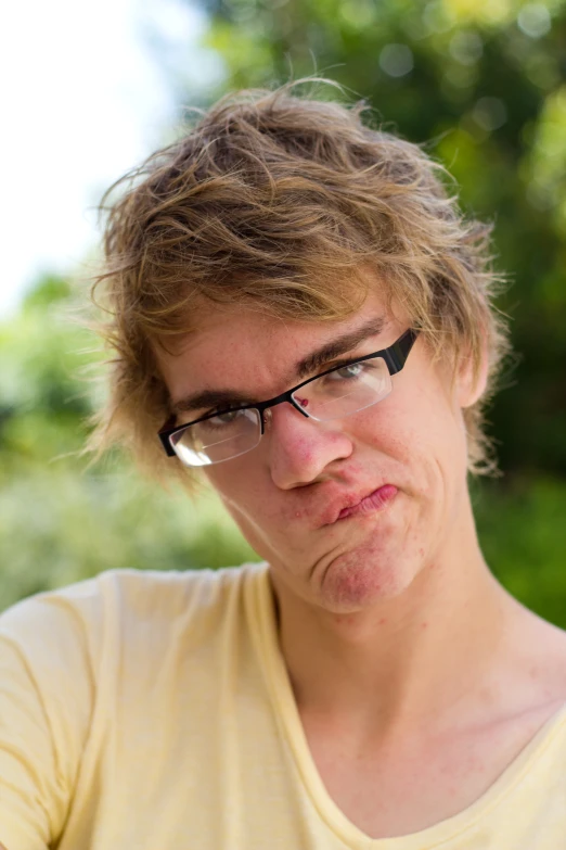 woman with black glasses holding a cell phone to her ear