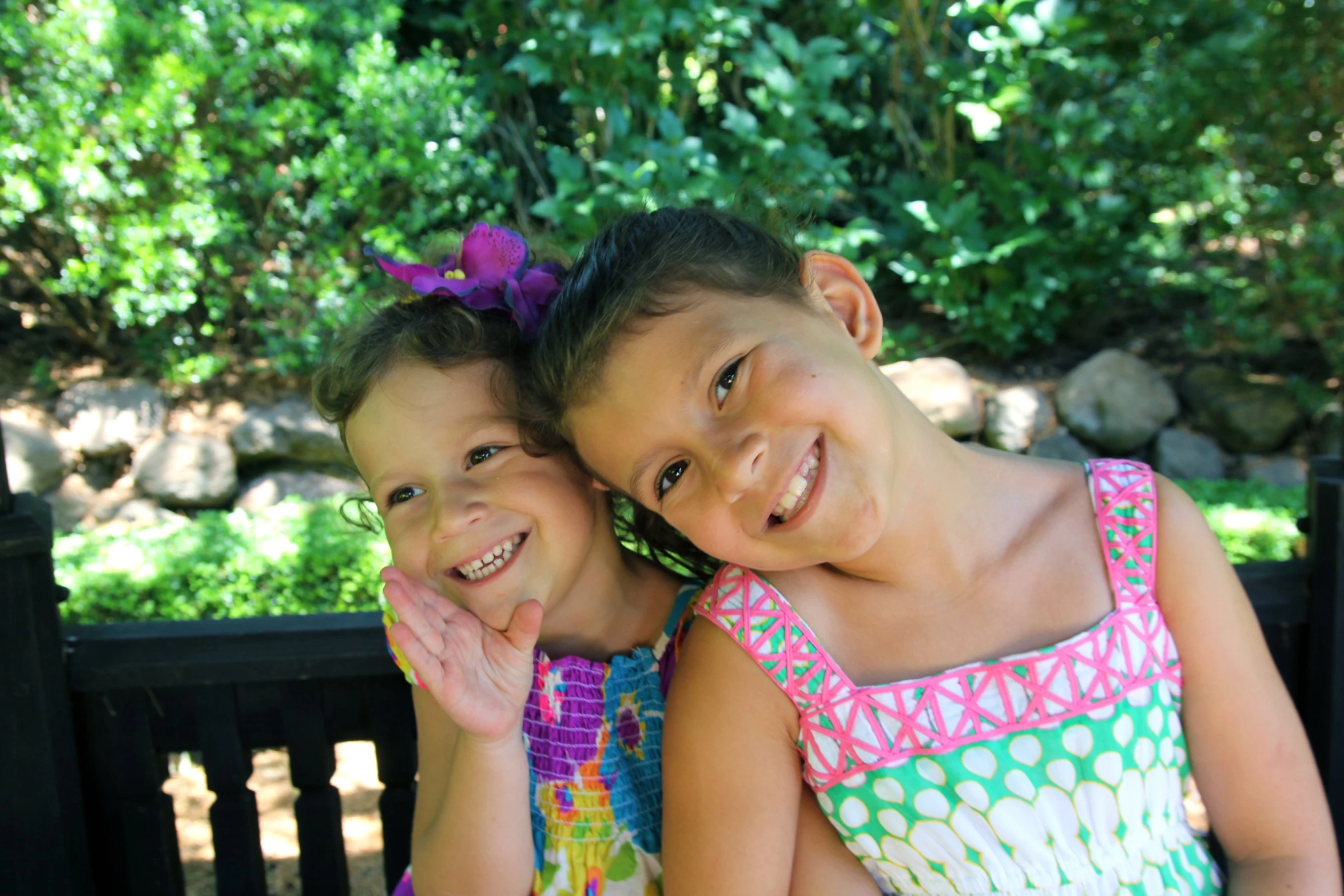 two little girls posing for a picture while wearing dresses