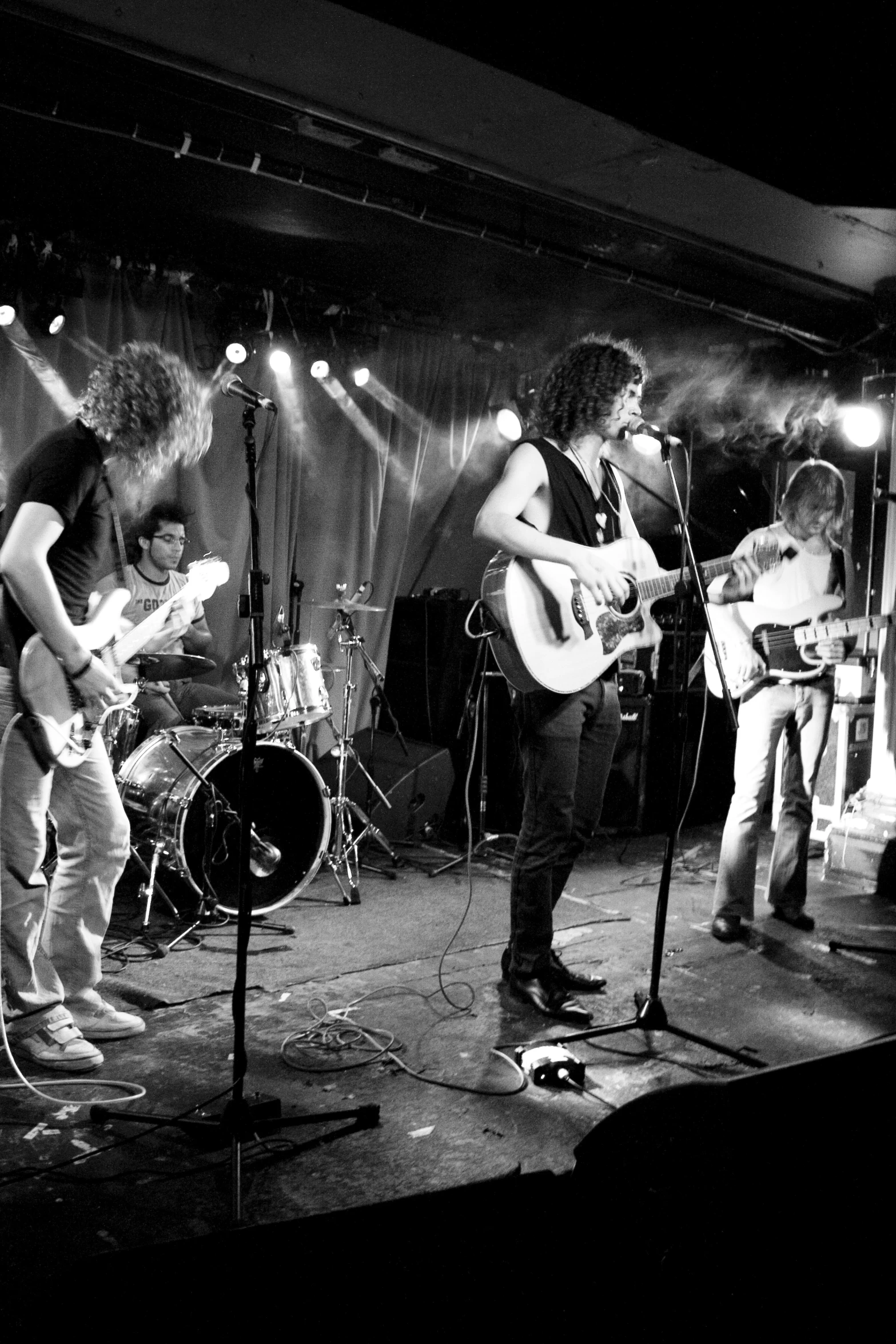 black and white pograph of band playing on stage