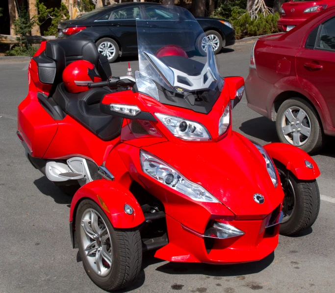 a red four wheeled vehicle parked in a parking lot