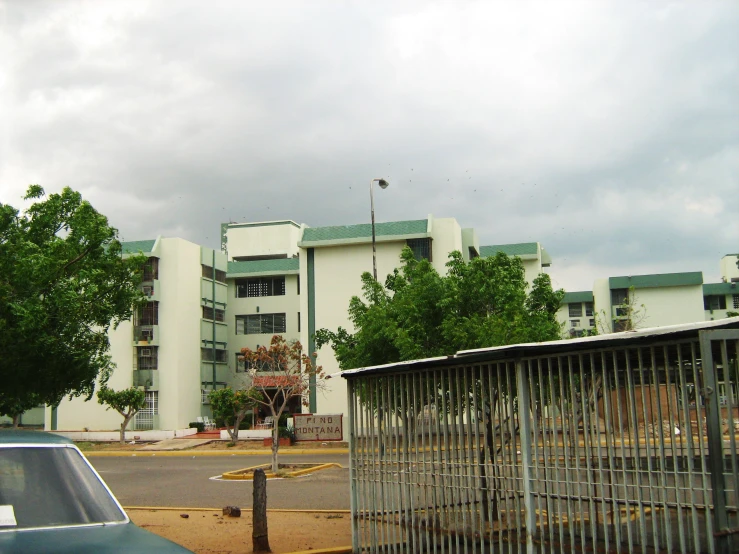 a birdcage in front of a building near a street