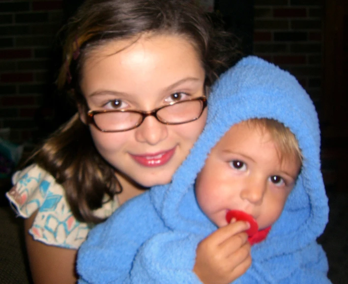 a close up of a person holding a baby wrapped in a towel