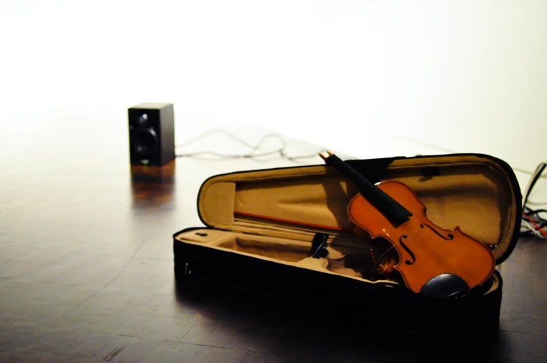 an open violin case sitting on top of a table