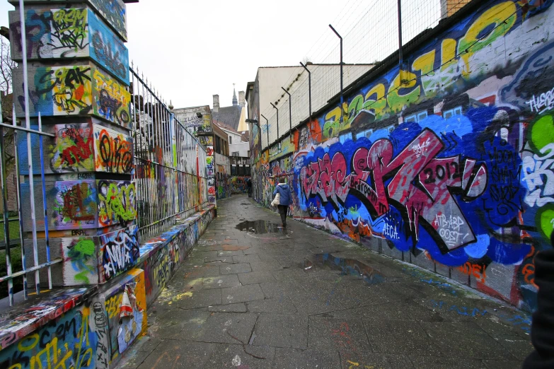 some very long graffiti covered buildings on the ground