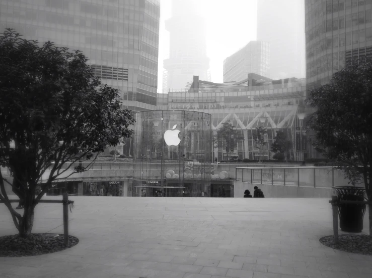 two people are sitting on a bench overlooking a building