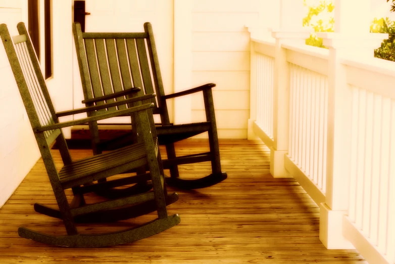 the porch has two rocking chairs on it