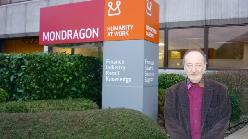 the man is standing in front of the signage