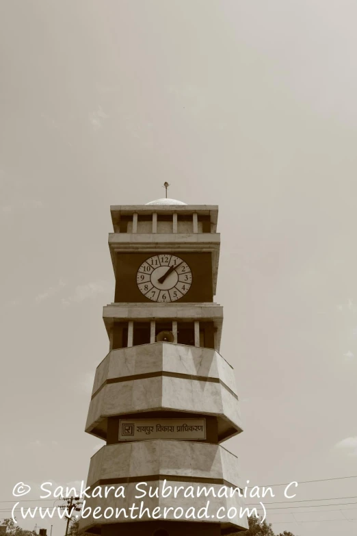 a clock tower has two flags on top