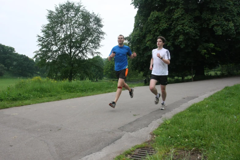 two men are running on a city trail