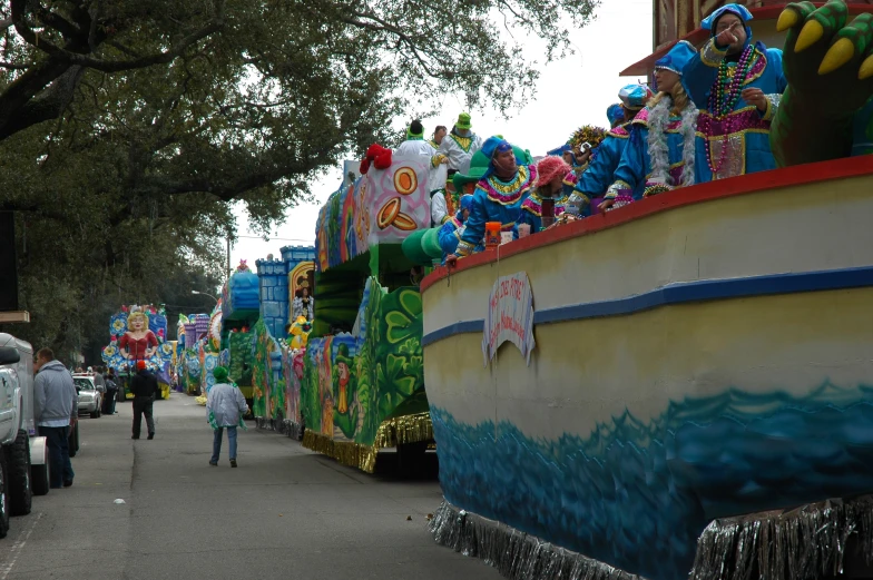 a person is walking down the street by some parade floats