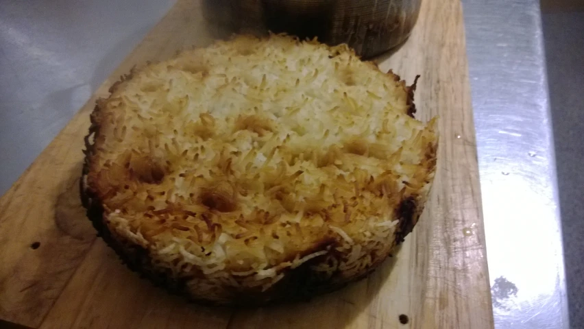 an open frying pan filled with food next to a bottle