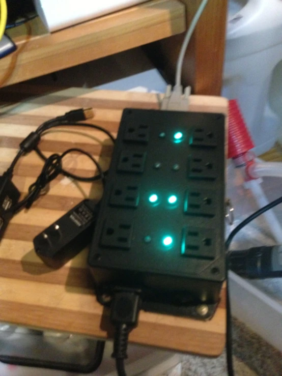 an electronic device sitting on a table in front of a charger