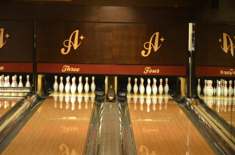 bowling pins sitting in a row with one man facing the other