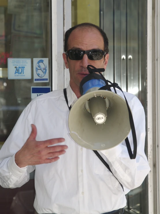 a man in sunglasses is holding a large bullhorn