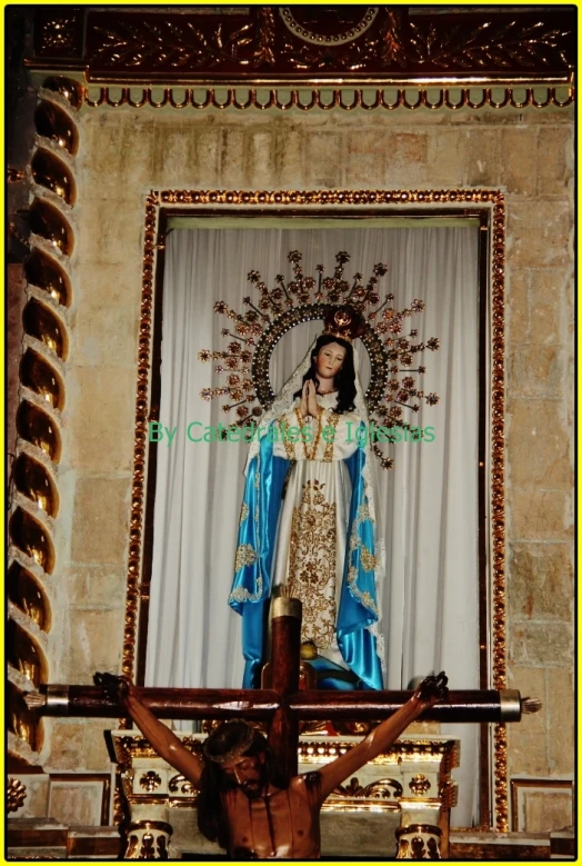 this is a po of jesus on the cross and the statue of mary