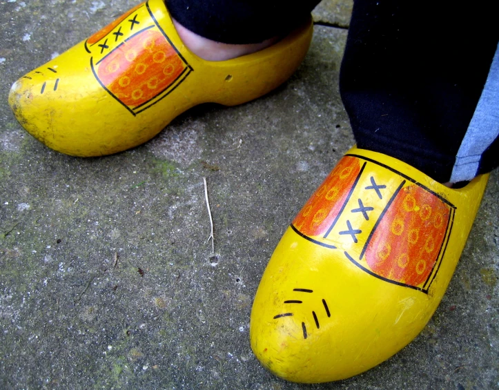 a close up of a person's feet wearing yellow shoes